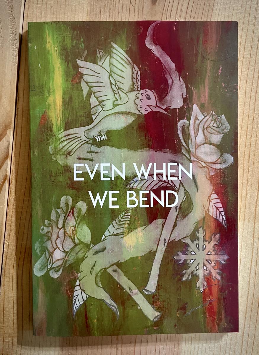 Book that reads "Even when we bend" with a hummingbird, snowflake, and roses on it