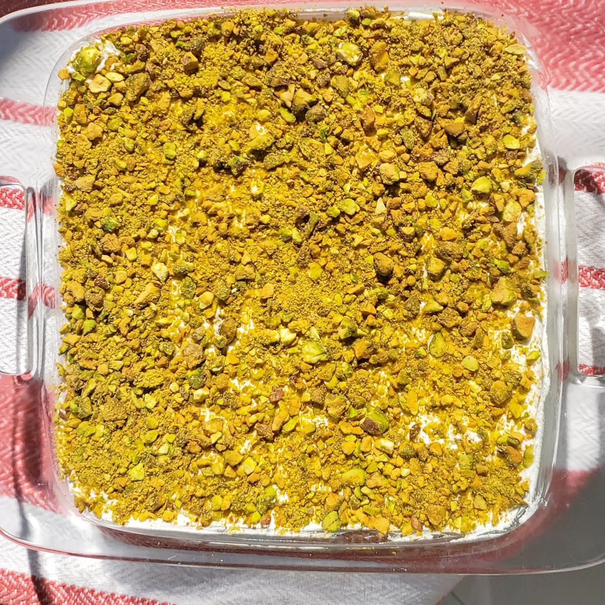 A tray of layali lubnan on a red-and-white striped cloth