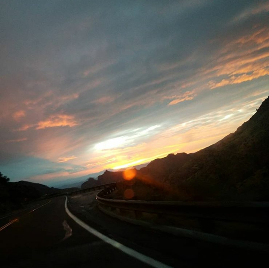 Sunset over curve in the road