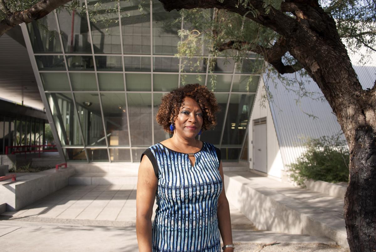 Rita Dove stands in front of a glass wall at the Poetry Center