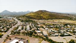 Aerial of neighborhood below a mountain