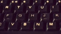 Close-up of black keyboard with a focus on F, G, H, & J keys