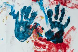 Kids handprints in blue and red, photo by Bernard Hermant