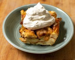 Bread pudding with whipped cream on a blue plate / photo by Tyler Espinoza