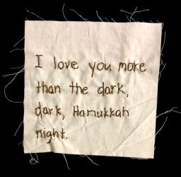 Embroidery reading, "I love you more than the dark, dark Hanukkah night."
