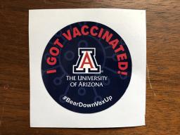 A round sticker that read "I got vaccinated" above the logo of the University of Arizona.