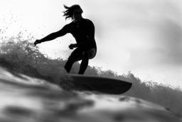 black and white image of someone surfing
