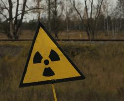 radioactive sign in front of a field