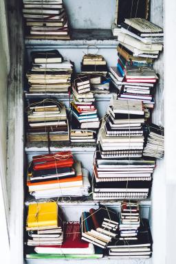 notebooks on an old bookshelf, photo by Julia Joppien