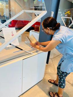 Poetry Center Archivist and Outreach Librarian Julie Swarstand Johnson adjusts materials in one of the new cases. 