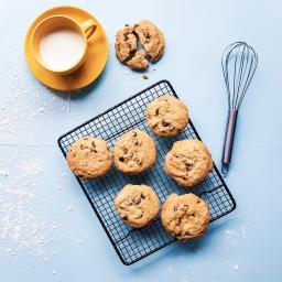 Chocolate chip cookies, milk, and a whisk on a blue table / Photo by Rai Vidanes