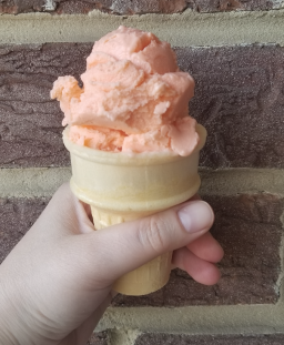A hand holds teaberry ice cream