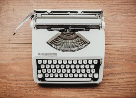 Gray typewriter on a wooden table