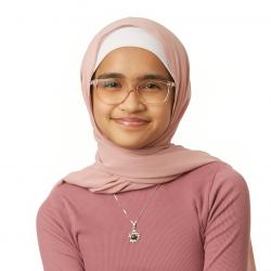 Smiling person wearing a pink sweater, pink hijab, and pink glasses