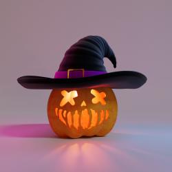 Jack o lantern with light in it wearing a witch hat