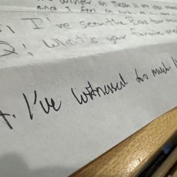 Image of a folded piece of paper covered in handwritten questions and answers. 