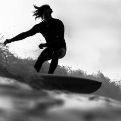 black and white image of someone surfing